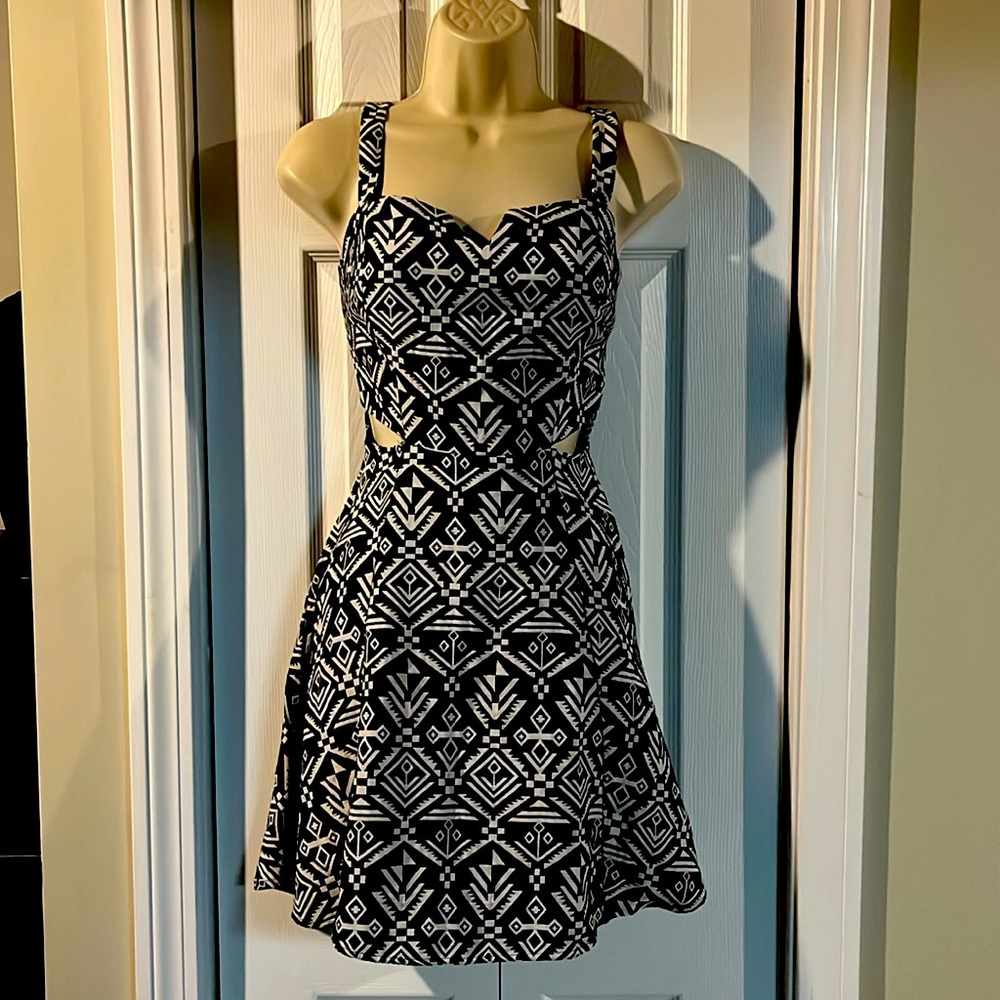 Small and short women dress. Has cutout on each side by waist.